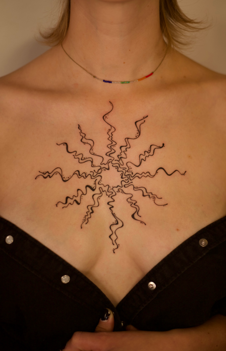 Swirly Sun Chest Tattoo