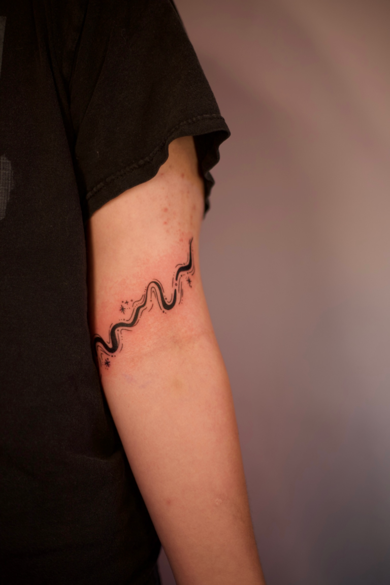 Swirly Elbow Wrap Tattoo With Stars